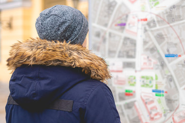 young tourist look on city map b