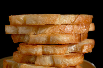 White toasted bread stacked in a pile on a plate. Shallow depth of field