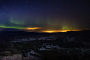 Urridafoss in southern iceland during a night with northern lights, waterfall with aurora 