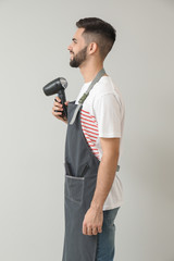 Naklejka premium Male hairdresser on light background