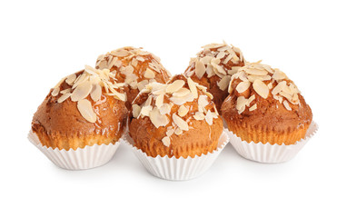 Tasty almond muffins on white background