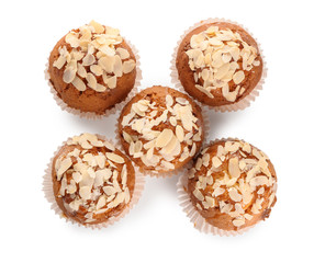 Tasty almond muffins on white background