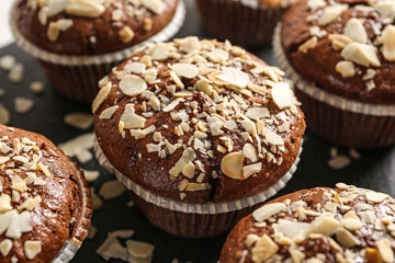 Tasty almond muffins on slate plate, closeup