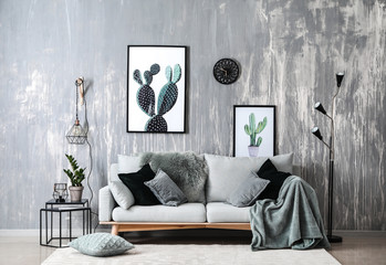 Stylish interior of room with soft sofa and new lamps