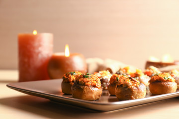 Tasty stuffed mushrooms on plate, closeup