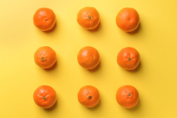 Tasty tangerines on color background