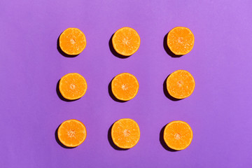 Ripe cut tangerines on color background