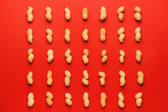 Tasty peanuts on color background