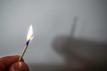 Fire match not throwing a shadow. Play of light and shade Experiment - optical illusion.