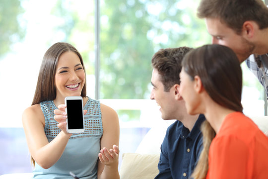 Woman Showing Blank Phone Screen To Her Friends