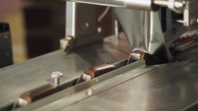 Dairy factory, production of glazed curds, packing process of chocolate glazed curd bars.