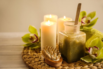 Beautiful spa composition with burning candles on white table