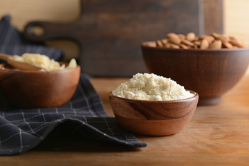 Fototapeta na wymiar Bowl with tasty almond flour on wooden table