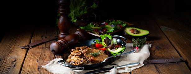 Pork steak with mushrooms and buckwheat groats and mango salad
