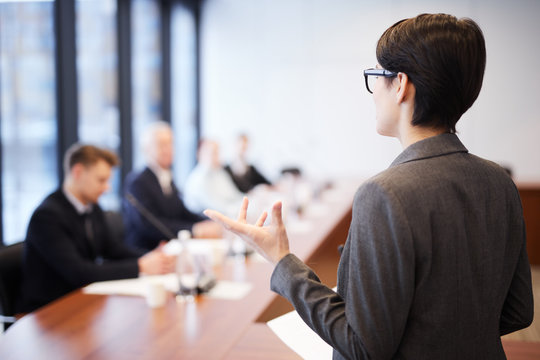 Back View Portrait Of Young Businesswoman Giving Speech In Conference Room And Gesturing, Copy Space