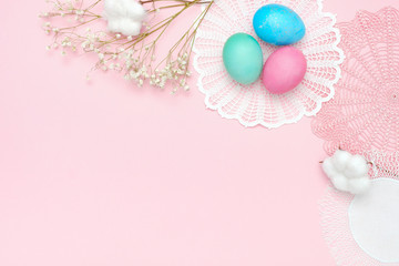 Fototapeta na wymiar Easter eggs and napkins on pastel pink background. Top view, flat lay, Easter holiday concept, banner mockup.