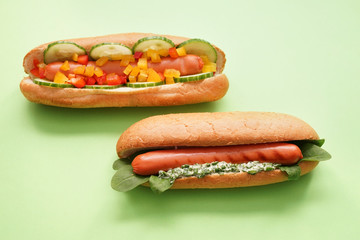 Tasty hot dogs on color background