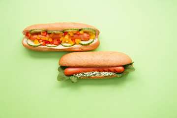 Tasty hot dogs on color background
