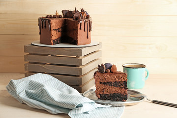 Composition with tasty chocolate cake on table