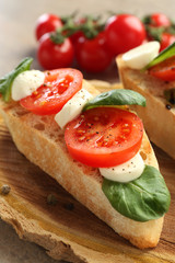 Fresh tasty bruschetta on wooden board, closeup