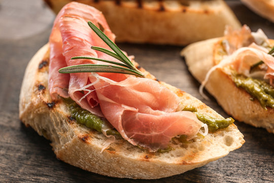 Fresh tasty bruschetta on wooden board, closeup