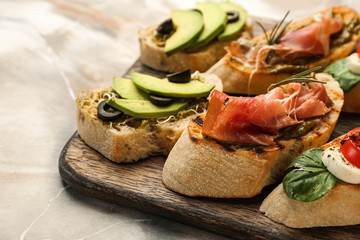 Fresh tasty bruschettas on wooden board