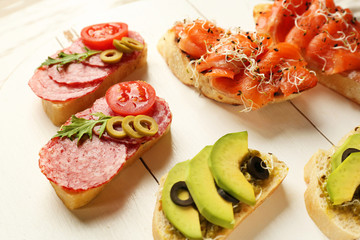 Fresh tasty bruschettas on wooden table