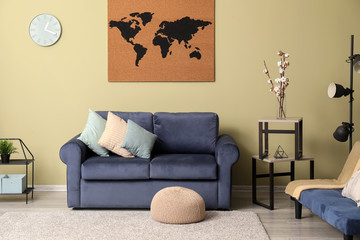 Interior of modern room with sofa and picture of world map