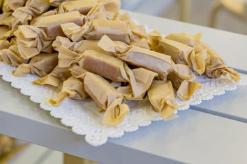 close up of handmade toffees wrapped in craft paper.