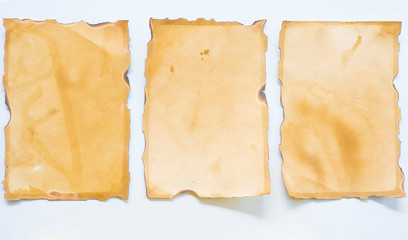 Old paper with multiple burns on a white background
