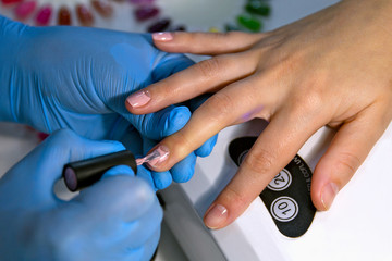 Master makes a  making fashionable manicure in beauty salon. Professional manicure.The concept of beauty and fashion.