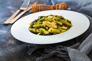 Pasta with pesto sauce and nuts on a the table