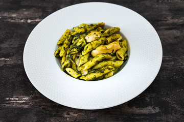 Pasta with pesto sauce and nuts on a the table