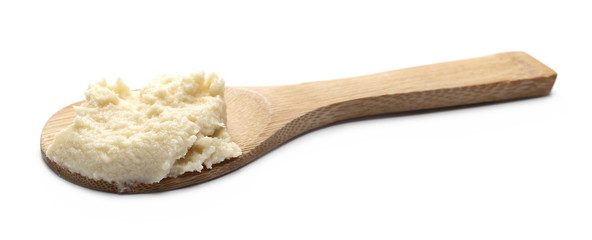 Horseradish sauce in wooden spoon isolated on white background