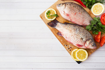 Raw carp fish with spices and vegetables for cooking. The view from the top. Copy space.