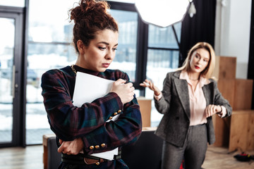 Curly dark-haired trainee feeling emotional after not getting job