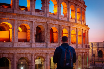 Rome/Italy 21 february 2019 :man standing in front of colosseo in Rome he admires the greatness of this landmark