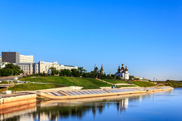 River Tura Embankment in Tyumen, Russia. Holy Trinity Monastery in the back.