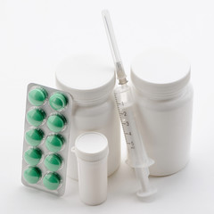 Different pills and syringe