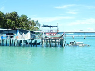 Romantic seascape in a beautiful bay, wooden jetty, Malaysia, island, Malacca Strait, concept of vacation, travel.