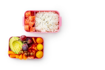 Creative layout with healthy lunch dishes variety in bento boxes on wooden table. Sandwich, slad with grains and pomegranate seeds, salmon with rice and fruit snacks. Office or school lunch concept