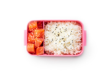 Creative layout with healthy lunch dishes variety in bento boxes on wooden table. Sandwich, slad with grains and pomegranate seeds, salmon with rice and fruit snacks. Office or school lunch concept
