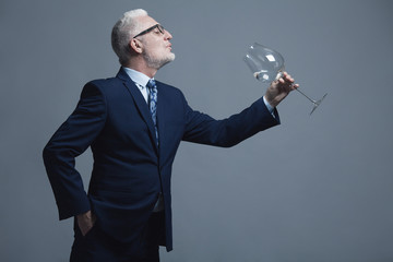 Stand-up party concept. Funny businessman with silver hair in expensive blue costume and trendy...