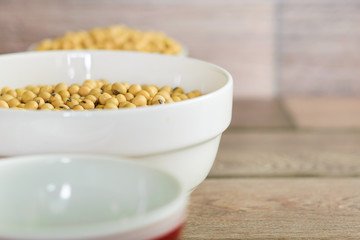 Soybean in a white bowl on wooden floor