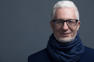 Fabulous at any age concept. Close up portrait of 60-year-old man wearing trendy accessories,...