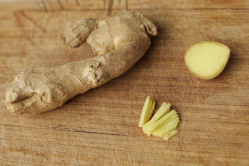 The ginger fruit is fresh, chopped finely, lies on a light wooden base, the concept of health and food