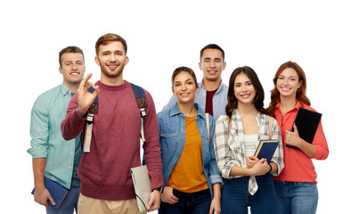 education, high school and people concept - group of smiling students with books showing ok hand sign over white background