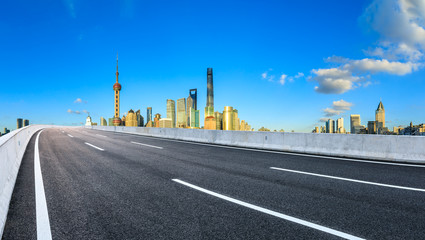Fototapeta na wymiar Asphalt road passes through Shanghai Lujiazui Financial District