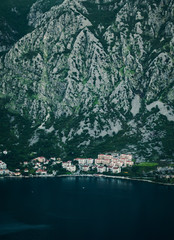 Evening photo of a small old European city at the foot of the mountain in the bay right near the sea