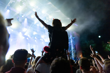 Fototapeta na wymiar Crowd enjoying in live concert at music festival by night.